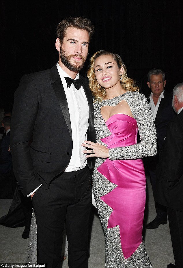 On and off: Miley and Liam previously announced their engagement in 2012 but broke up the following year. They rekindled their relationship in 2016. Pictured here at an Oscars viewing party in Los Angeles in March  2018