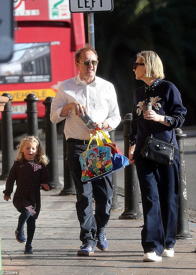 Child's play: Andrew carried a colourful Wiggles bag, which presumably belongs to Edith