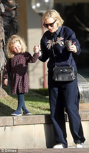 Playful: The actress held her daughter's hand as they walked together
