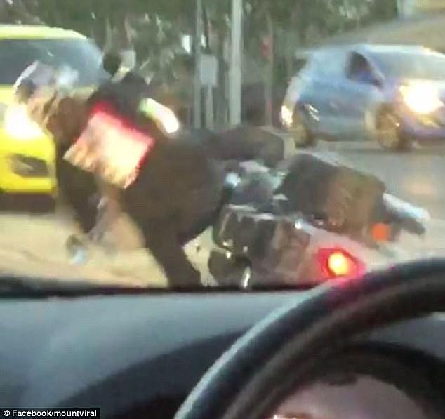 A motorbike rider who tried showing off at a set of lights had a nasty shock when he attempted to speed off