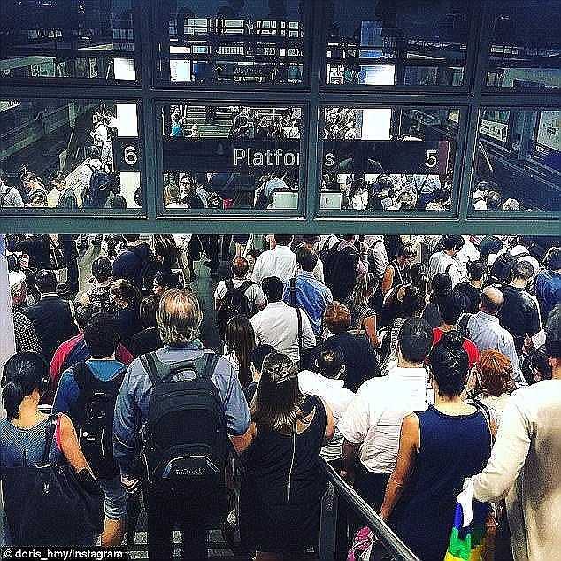 Australia's most powerful banker has credited high immigration with boosting the economy as he addressed elites who had paid $225 for a three-course lunch (Sydney's Town Hall at peak hour station pictured)