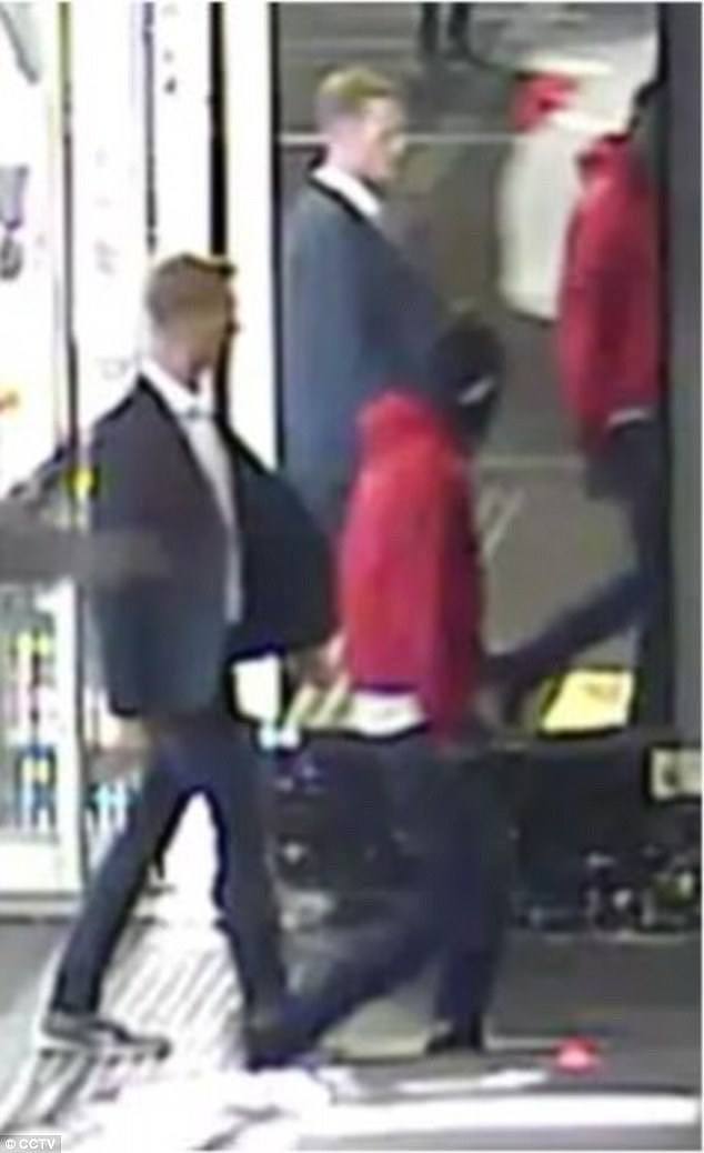 The man (pictured in red hoodie) approached the girl and put his arm around her shoulders and neck before the assault, police said