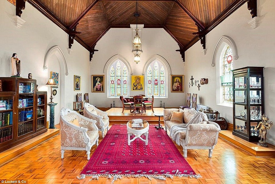 Â The converted convent has retained many of its original features including stained glass windows, marble fireplaces and timber flooring (pictured is the former 'chapel' which is now a sitting room)