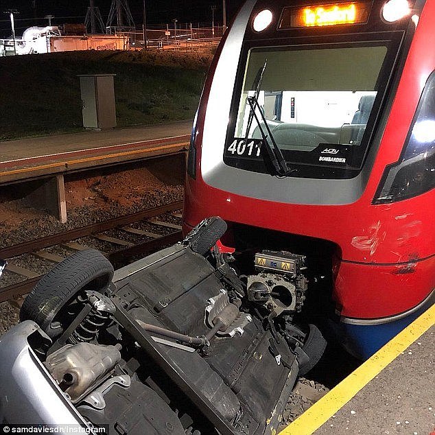 Two men intentionally pushed car onto train tracks before running off just shortly before it was struck by passenger train