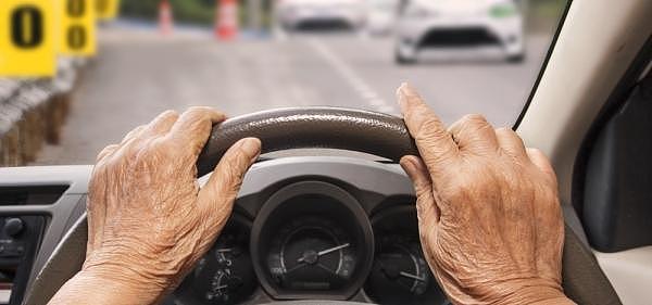 older_driver_with_hands_on_steering_wheel_web.jpg,0