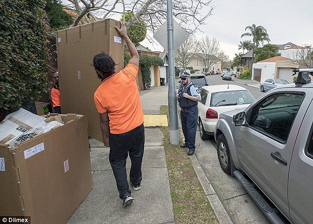 A police officer kept watch as the removalists worked outside the Turnbull's $52million Point Piper mansion