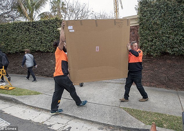 Members of the public seemed unfazed by the sight of the removalists, walking past them on a footpath outside the Point Piper mansionÂ Â 