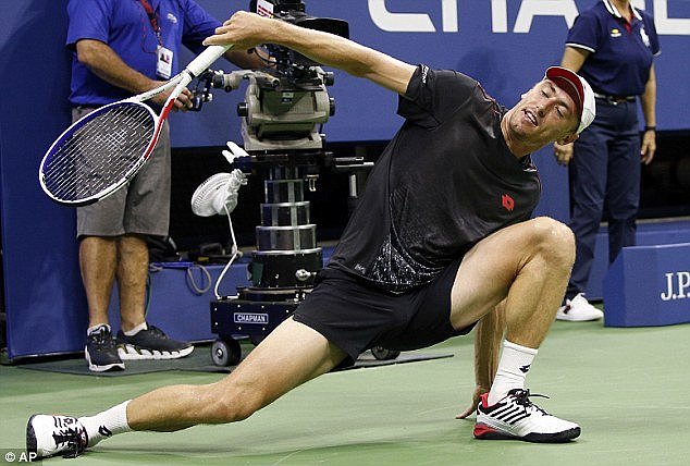 John Millman, of Australia, loses his footing after returning a shot to Roger Federer - before going on to win the matchÂ 