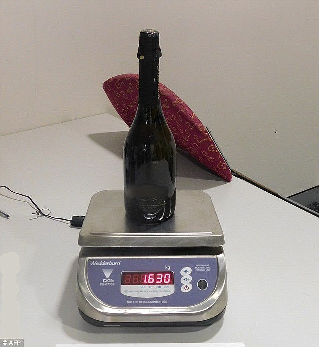 The 33-year-old was arrested at Sydney Airport on Monday after arriving on a flight from Peru (pictured is one of the wine bottles allegedly carried by the man)