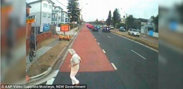 An elderly lady, dressed in all-white, was seen crossing three lanes of traffic on Pittwater Road when a Sydney bus narrowly missed her by inches