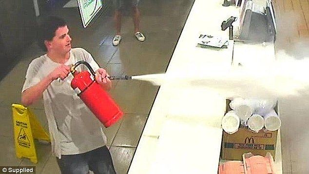 Police are hunting for two men who used a fire extinguisher to spray staff at a fast food restaurant after being ejected from the premises