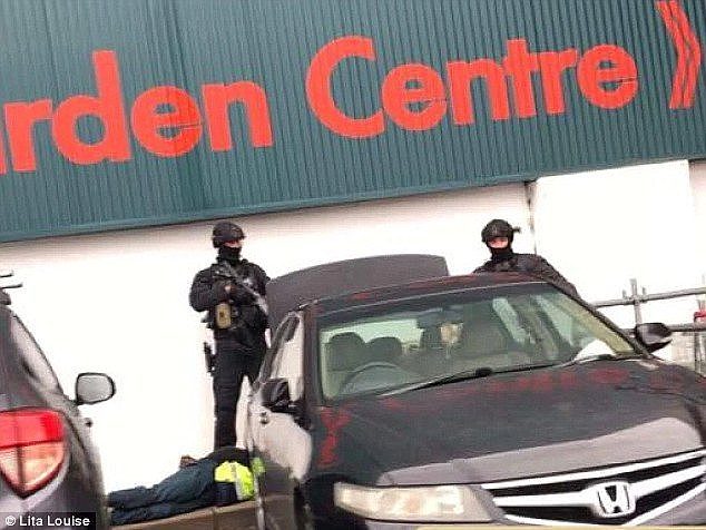 Heavily armed tactical police have arrested three people outside a Bunnings Warehouse (pictured)