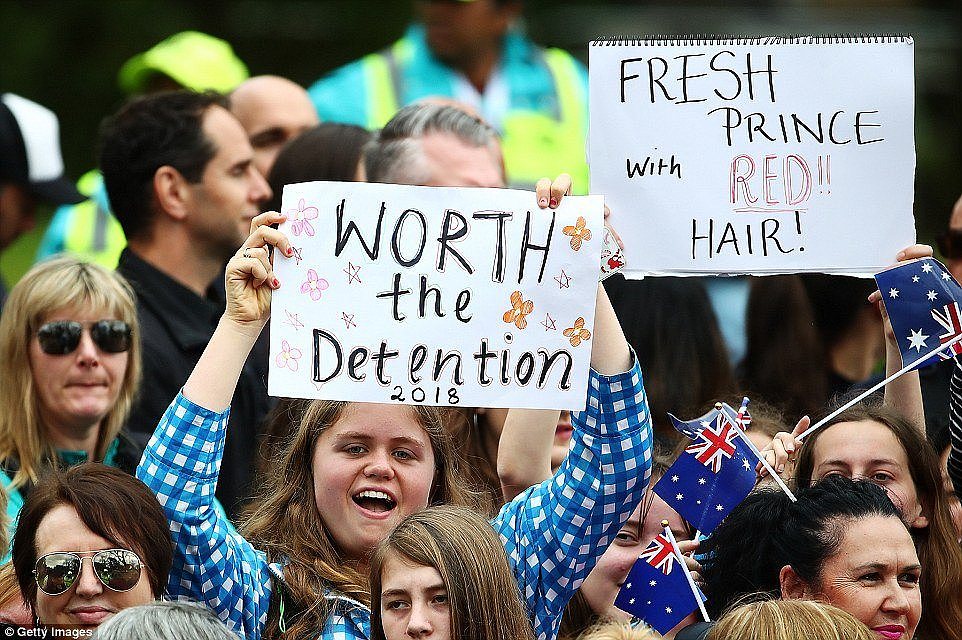 Many are carrying signs including two witty notices reading: 'Worth the detentionâ and the âFresh Prince with Red Hairâ