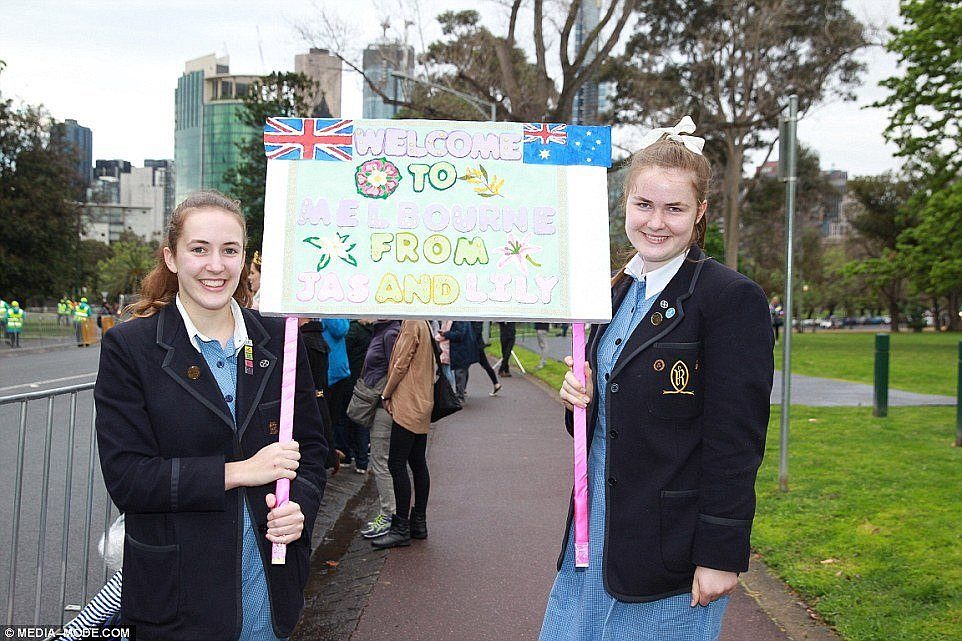 Two Melbourne schoolgirls are pictured with a welcome sign ahead of Prince Harry and Meghan's arrival in Melbourne