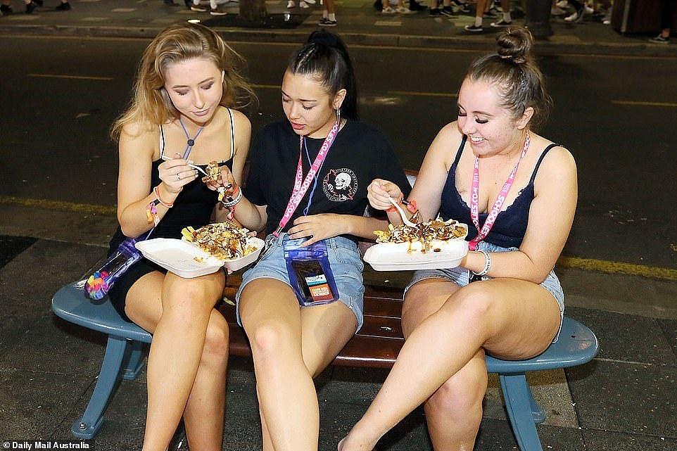 A group of girls indulge on kebabs before the end of the night. They were enjoying the food almost as much as they were enjoying the warm weather