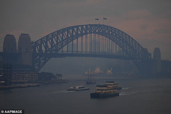 21726016-7748433-Commuter_ferries_sail_past_the_Sydney_Harbour_Bridge_as_smoke_ha-a-10_1575326189424.jpg,0