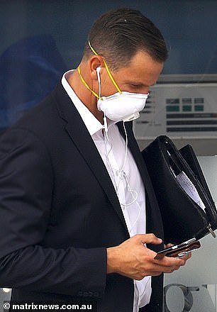22037358-7774927-Office_attire_featured_masks_pictured_a_man_on_his_phone_on_Tues-m-6_1575954054810.jpg,0