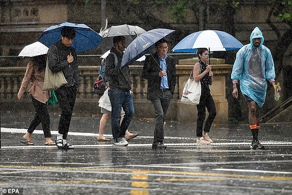 24279472-7966707-Pedestrians_hold_umbrellas_as_they_walk_in_heavy_rain_in_Sydney_-a-11_1580854931634.jpg,0
