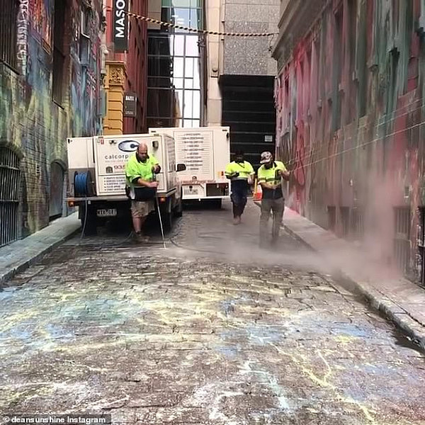 24670776-7997333-Street_cleaners_can_be_seen_washing_paint_off_cobbled_streets_of-a-2_1581550690789.jpg,0