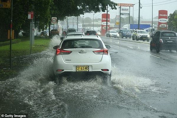 24665076-8001585-Cars_travel_through_flooded_roads_in_Sydney_on_Sunday_after_a_he-a-7_1581628327165.jpg,0