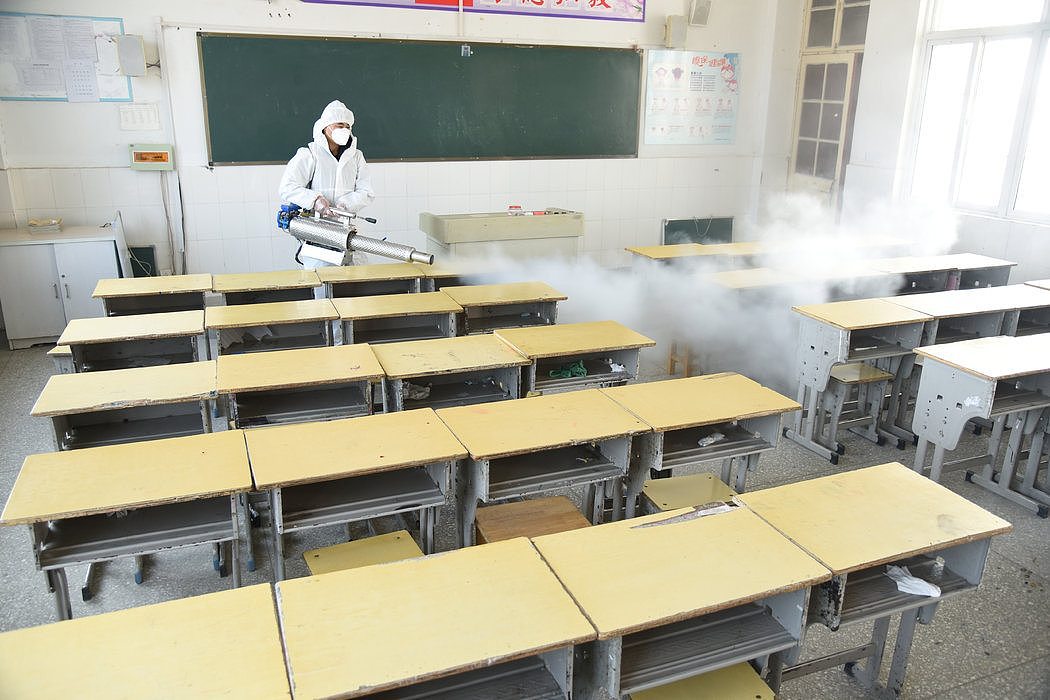 江苏，一名工作人员在对教室进行消毒。