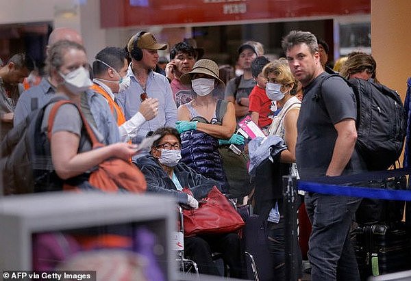 26140550-8128071-Anxious_scenes_At_the_same_time_at_the_airport_travellers_queued-a-41_1584574882812.jpg,0