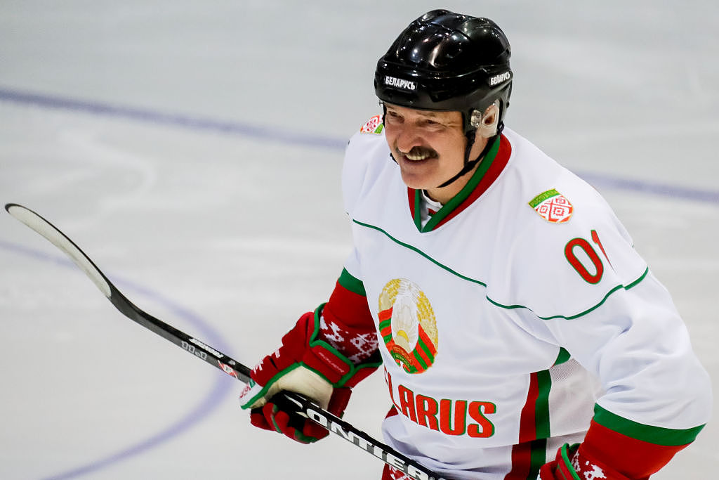 Belarus president Lukashenko playing hockey during a visit to Socchi in Russia
