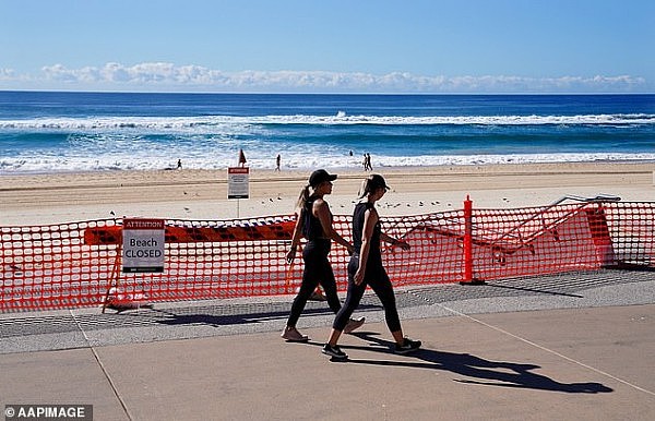 27280544-8224269-Walkers_exercise_past_a_closed_section_of_Surfers_Paradise_Beach-a-3_1587057596798.jpg,0