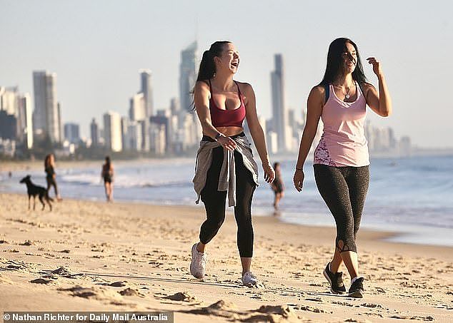 27658830-8267563-Two_walkers_laugh_on_Burleigh_beach_on_Sunday_morning_Queensland-a-9_1588124641327.jpg,0