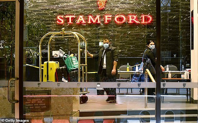 30137190-8468025-Staff_inside_the_Stamford_Hotel_in_Melbourne_wearing_masks_are_s-a-6_1593376260461.jpg,0