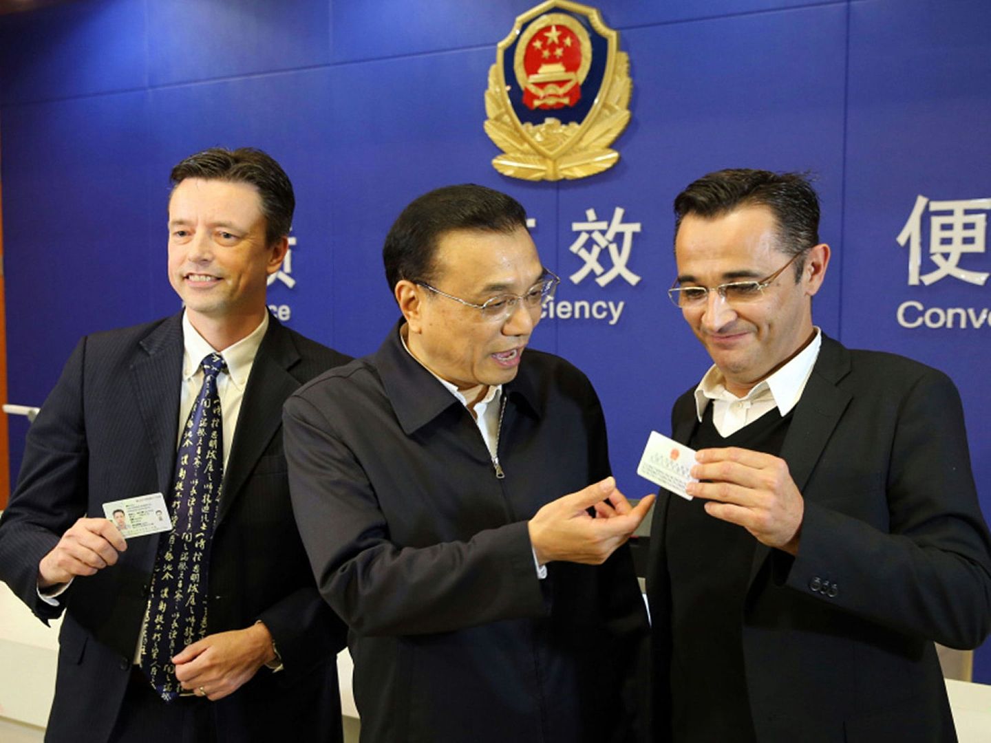 图为2015年11月25日，中国总理李克强考察上海自贸区时，见证荷兰和法国两位外籍人士获得永久居留证。（中国政府网）