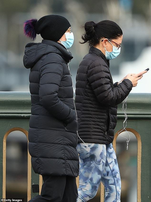 31110090-8554987-Two_women_in_face_masks_go_for_a_walk_across_Princes_Bridge_in_M-a-8_1595573152428.jpg,0