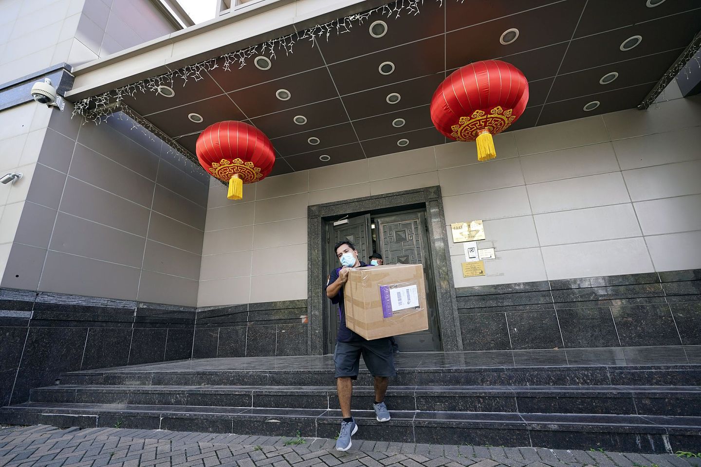 一名美国联邦快递工作人员进入中国驻休斯敦总领馆开始搬运物品。（AP）