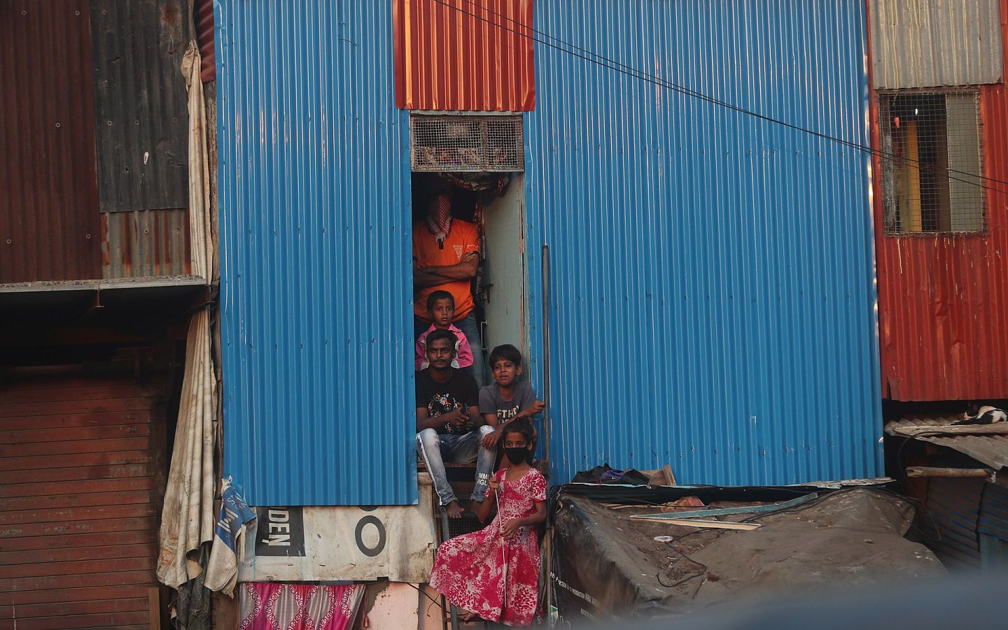 在2020年4月14日“封锁2.0”后，印度孟买的贫民窟门前已经出现了抗议者，人们站在一所房子的门口，抗议延长封锁以致无法做工维持生计。（美联社）