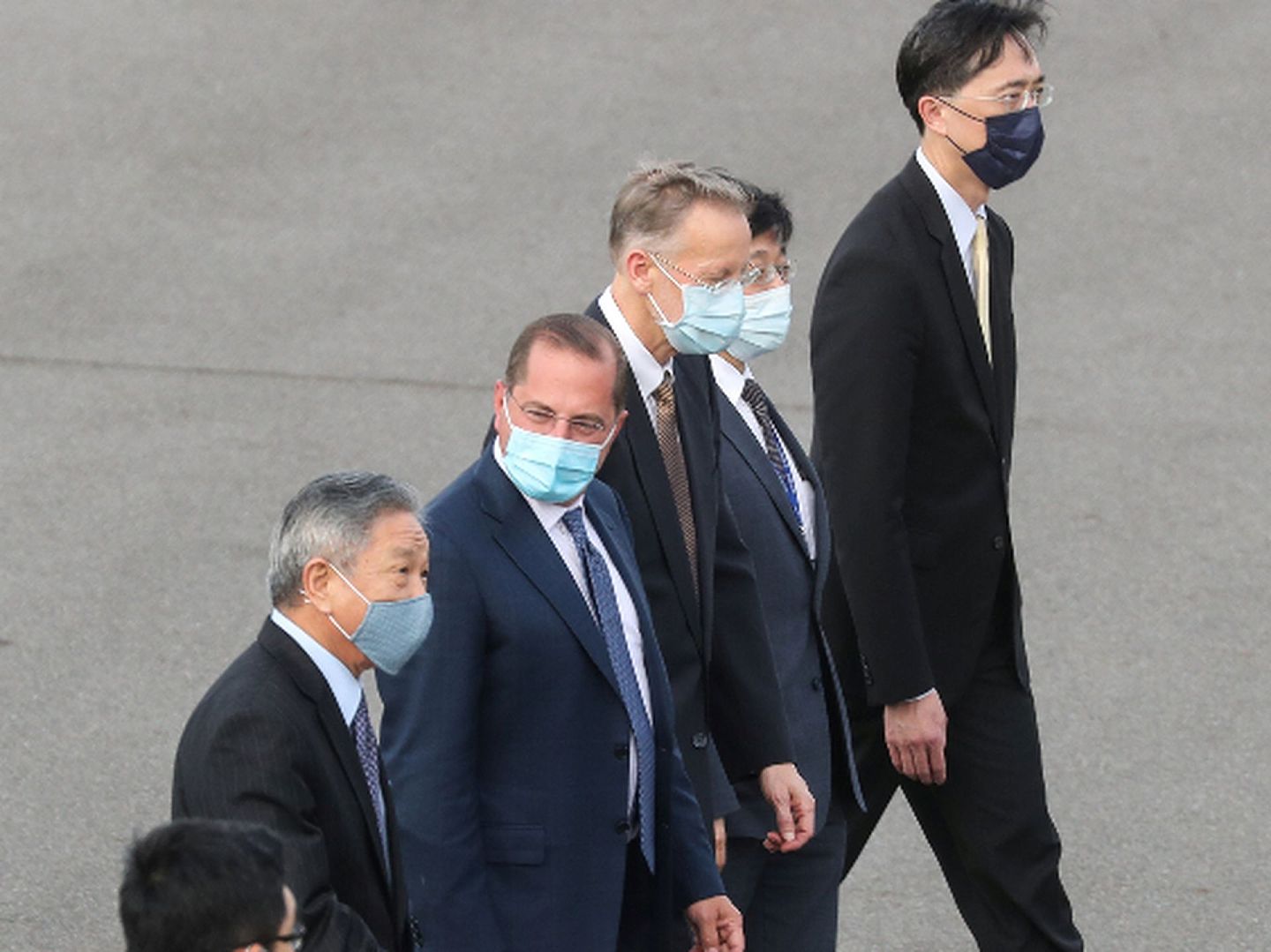 台湾的接机人员也都戴着口罩，疫情仍然令人警惕。美国的新冠肺炎疫情是全球最严重的。（Reuters）