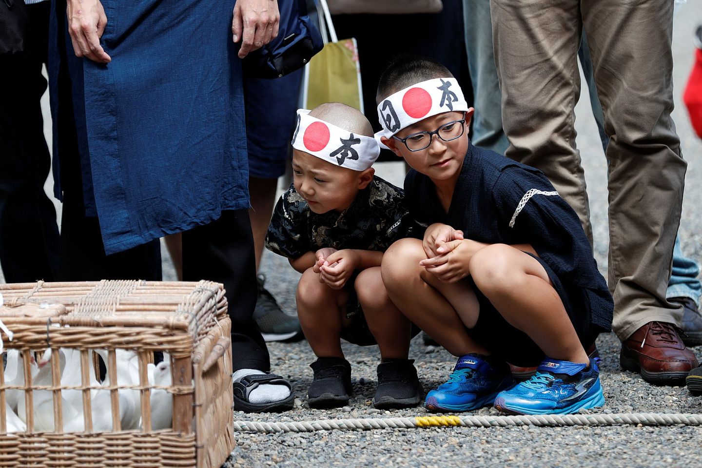 2019年8月15日，在靖国神社中戴着印有日本国旗的头巾的男孩们。（Reuters）