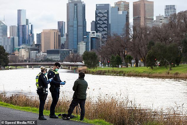 32169364-8646233-A_photographer_is_quizzed_by_police_during_stage_four_lockdown_r-m-12_1597912638160.jpg,0