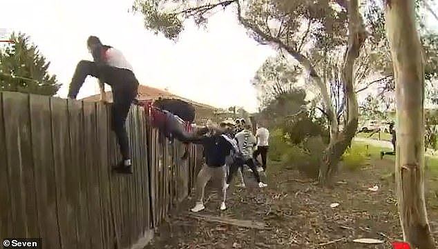 32561150-8678567-Footage_shows_some_of_the_men_destroying_a_fence_to_a_private_pr-m-40_1598778537196.jpg,0