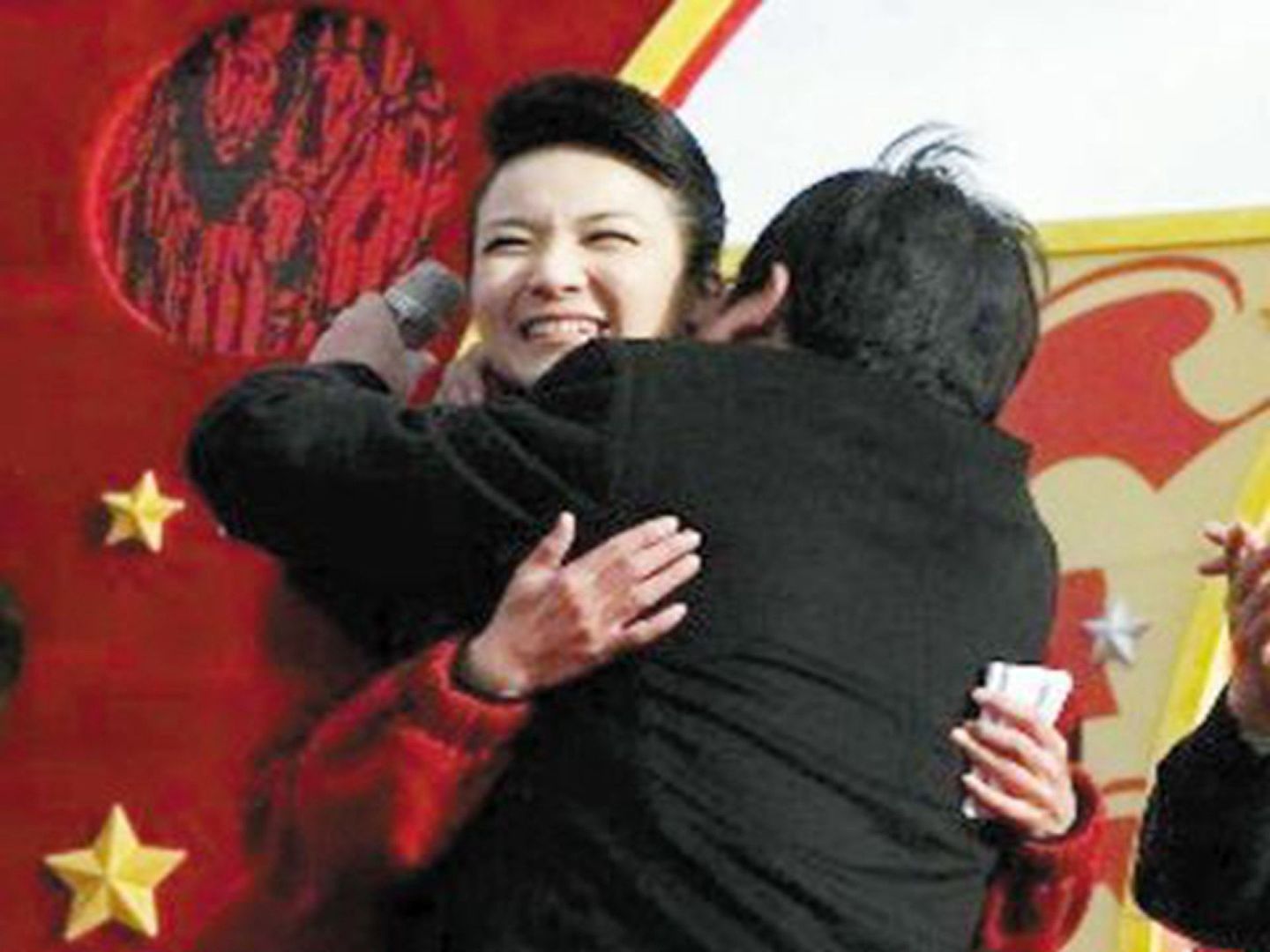 2010年12月25日，祁玉江熊抱主持人画面。（微博@财经微视角）