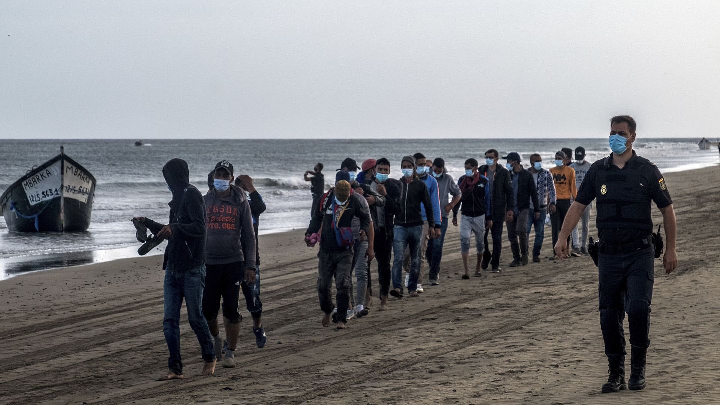 非法移民：图为10月20日，一批摩洛哥移民抵达西班牙加那利群岛，被警员押走。（AP）