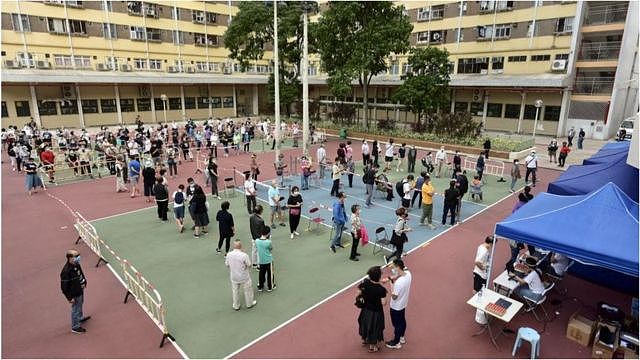 香港居民在临时检测中心排队接受新冠病毒检测。