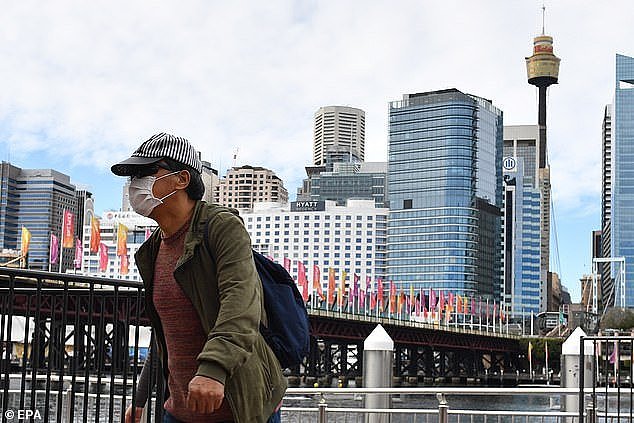31757566-8610373-A_pedestrian_wearing_a_face_mask_walks_at_Darling_Harbour_in_Syd-a-1_1597026308740.jpg,0