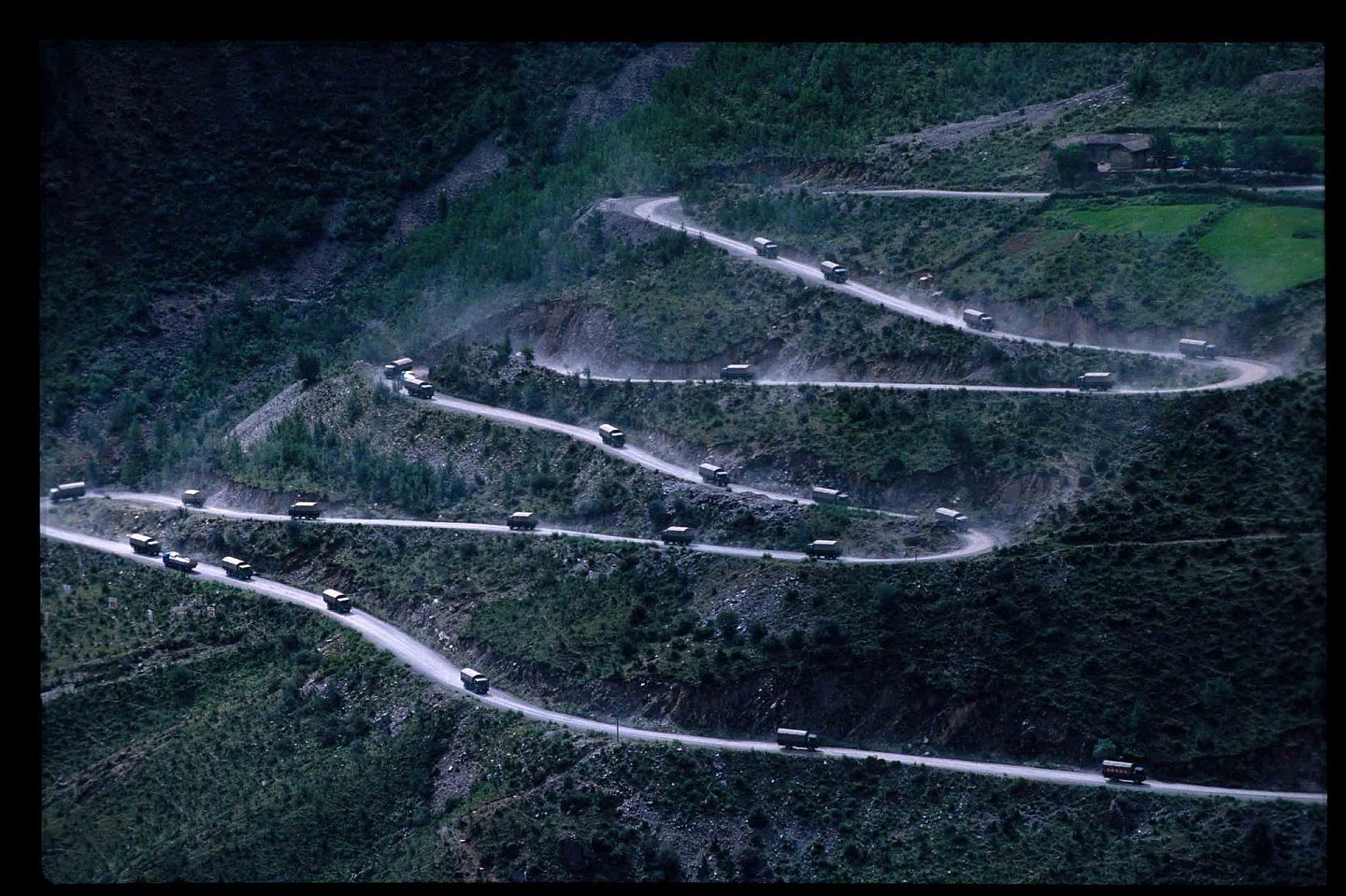 2004年，一队运送物资的军车穿行在蜿蜒的川藏线上。（视觉中国）