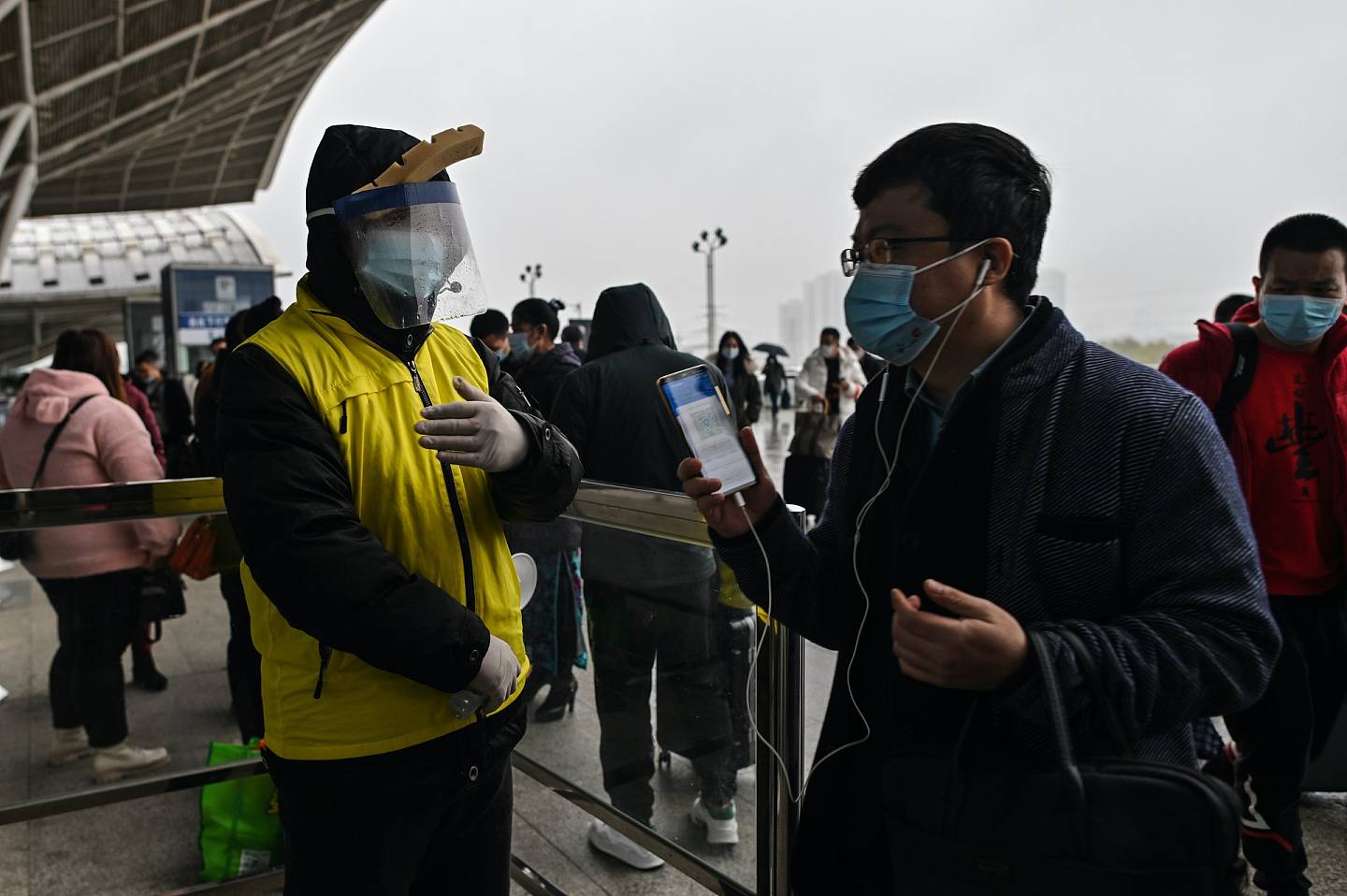 图为11月25日，武汉火车站，乘客正向职员展示健康码进站。 （Getty）