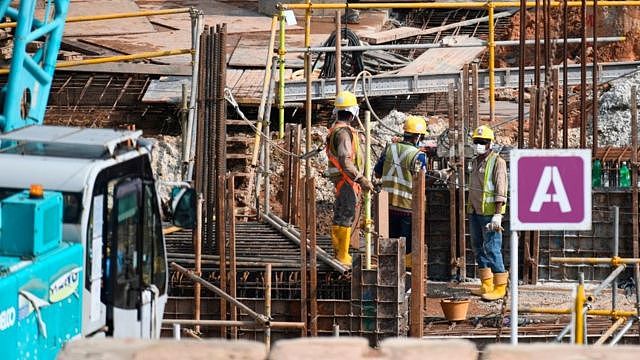 Migrant workers work at a construction site in Singapore on August 20, 2020.