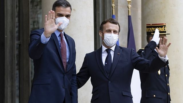 French President Emmanuel Macron (R) greets Spanish Prime Minister Pedro Sanchez (L)