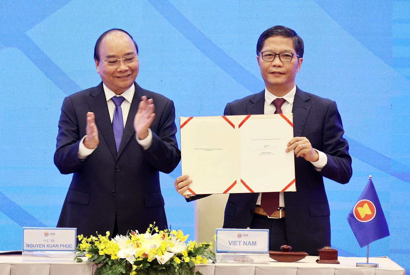 2020年11月15日，在越南首都河内，越南总理阮春福（左）出席RCEP签字仪式，越南工贸部部长陈俊英代表越南在协定上签字。（新华社）