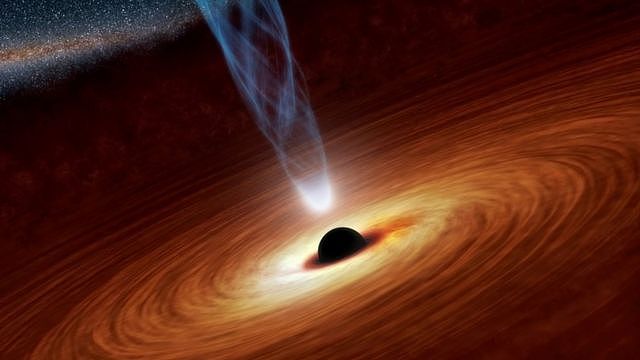 A supermassive black hole with millions to billions times the mass of our sun is seen in an undated NASA artist