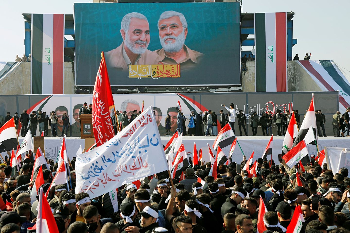 图为2021年1月3日，伊拉克巴格达有人纪念伊朗高级将领苏莱曼尼遇害一周年。（Reuters）