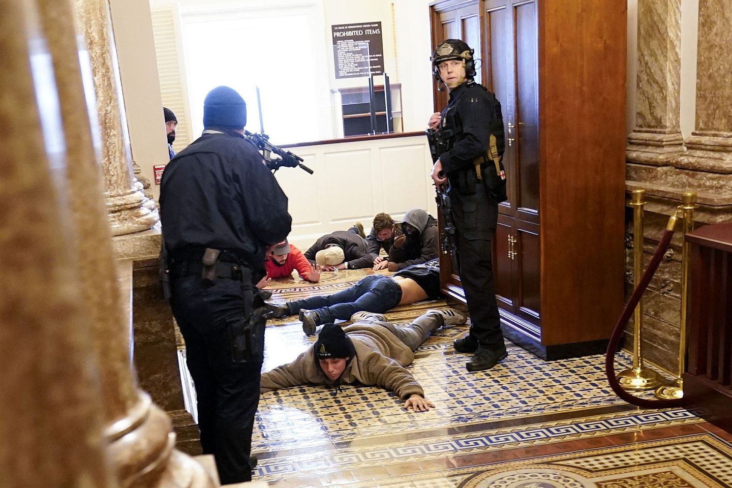 2021年1月6日，美国国会大厦的警察用枪指着抗议者。（AP）